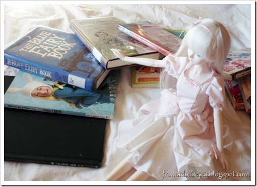 Ball Jointed Doll Showing Off Some Library Books