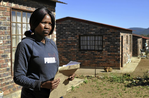 Tsholofelo Molefe of Groot Marico next to her RDP house that she has been denied access to.