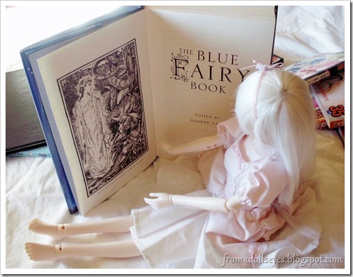 Bjd Looking at Illustrations in The Blue Fairy Book