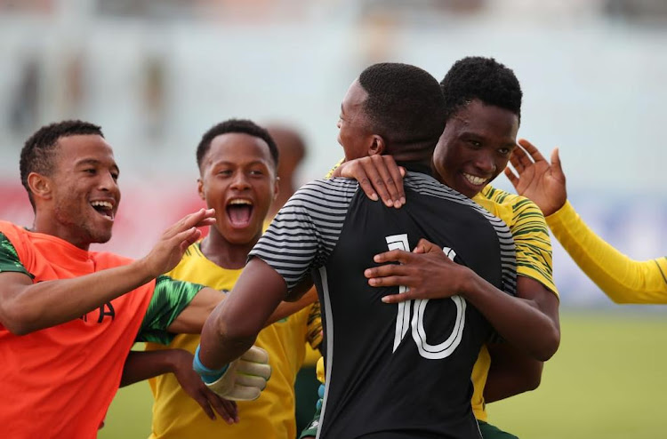 SA Under-20 players celebrate after scoring a goal.