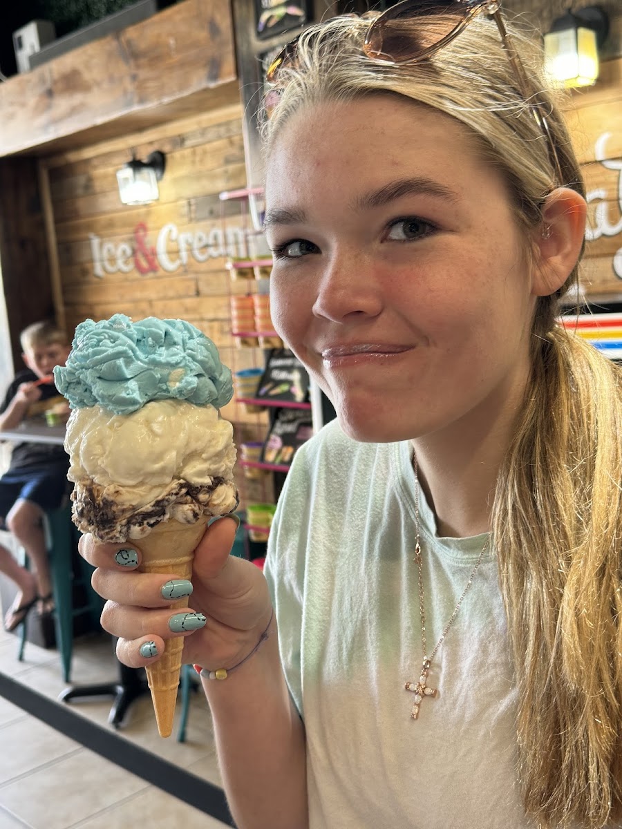 GF cone with a triple decker - going all out in vacation. Flavors are Smurf, tropical coconut twist and coconut almond fudge