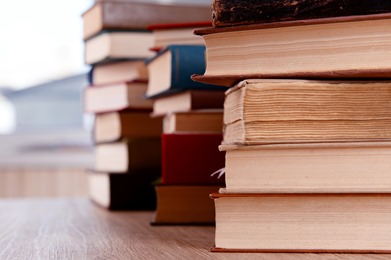 Stacks of books on table close up