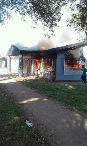 Residents of Toekomsrus in Randfontein west set alight a pay point at the municipal building.