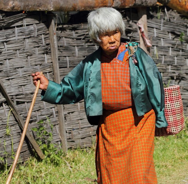 An Elderly Bhutanese Woman walks in Trongsa, Bhutan