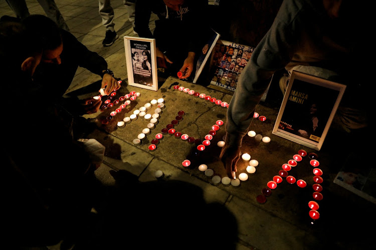 Demonstrators light candles during a protest following the death of Mahsa Amini.