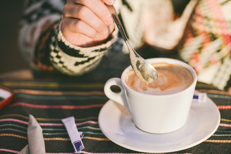 Woman Stirring Capuccino Coffee