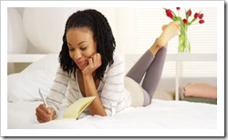 stock-footage-happy-black-woman-writing-in-journal