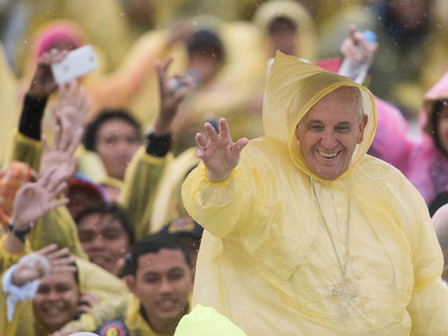 Pope Francis waves to well-wishers after a Mass in the Philippines, where he visited in January 20125 with survivors of a catastrophic typhoon. Photo: JOHANNES EISELE / AFP / Getty Images