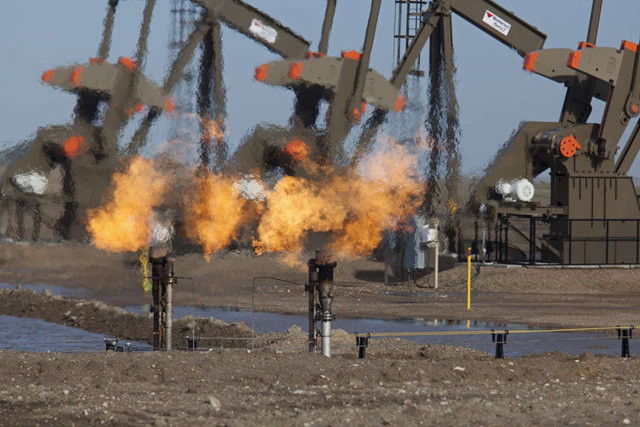 Natural gas is flared off as oil is pumped in the Bakken shale formation in Watford City, N.D. Photo: REX / imageBROKER