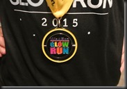 Cheryl shows off the Glow Run medal