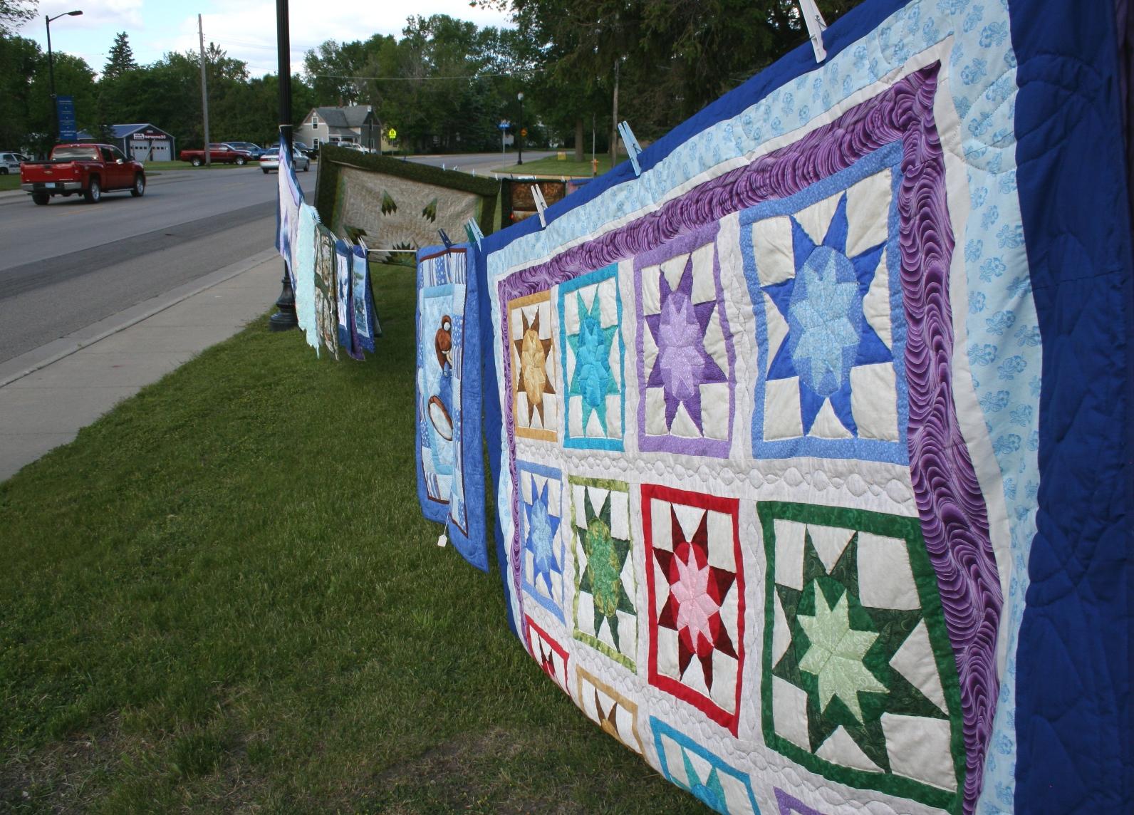 Beautiful, hand-stitched quilts stretched on the clothesline.