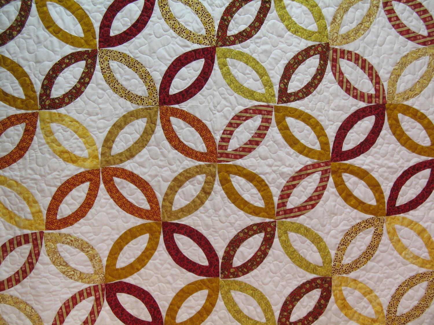 Double Wedding Ring Quilt in Yellows and Reds on White. From justsewquilts
