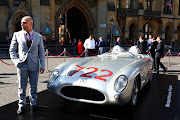 Elliot Moss poses beside his late father's Mille Miglia-winning Mercedes-Benz 300 SLR '722 at Westminster Abbey on May 8, 2024 in London, England. The former motor-racing driver died on April 12 2020, during the Covid pandemic, in London at the age of 90.