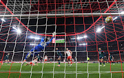 Joshua Kimmich scores for Bayern Munich past Arsenal's David Raya in their Champions League quarterfinal second leg at Allianz Arena in Munich on Wednesday night.
