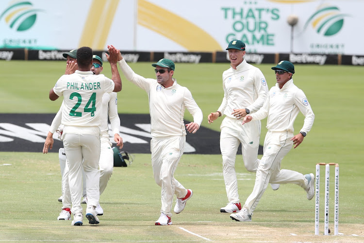 Vernon Philander celebrates a wicket of Rory Burns with teammates.