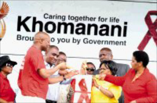 JOIN HANDS: From left, MEC for health and social development in Limpopo, Seaparo Sekoati, Limpopo premier Sello Moloto, health minister Manto Tshabalala-Msimang and Deputy President Pumzile Mlambo-Ngcuka light candles during the World Aids Day held at Mahwelereng Stadium in Limpopo on Saturday. Pic. Elijar Mushiana. © Sowetan.