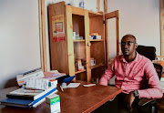Andrew Tendo, 31,a medical clinic officer sits at his working station at the Ice Breakers Uganda (IBU) clinic in Makindye that supports HIV/AIDS programmes and treatment for the LGBTQ community in Salaama road, Kampala, Uganda.