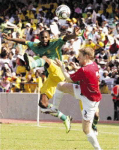 HIGH FLYERS: Bernard Parker of South Africa and Tom Hogil of Norway during the Nelson Mandela Soccer Challenge in Rustenburg. 29/03/09. Pic. Veli Nhlapo. © Sowetan.