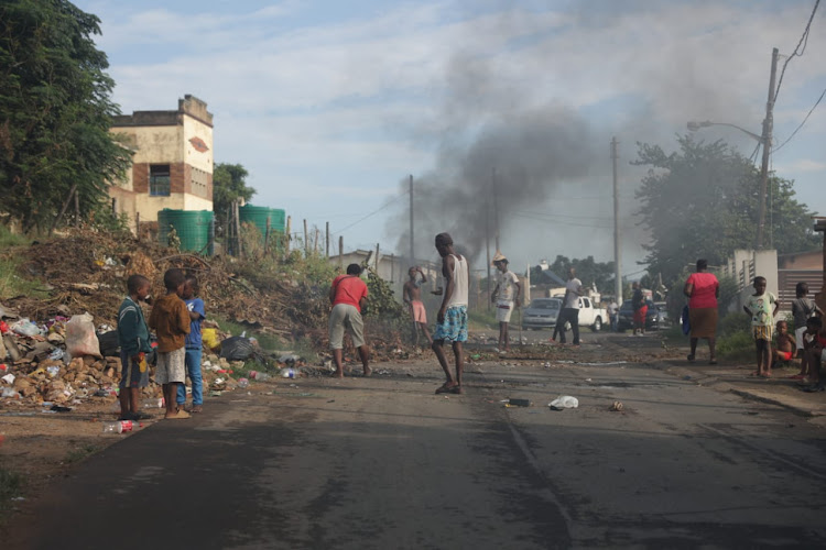 Inanda residents cleared burning debris and swept Zabalaza road after it was closed on Monday morning by protesters.