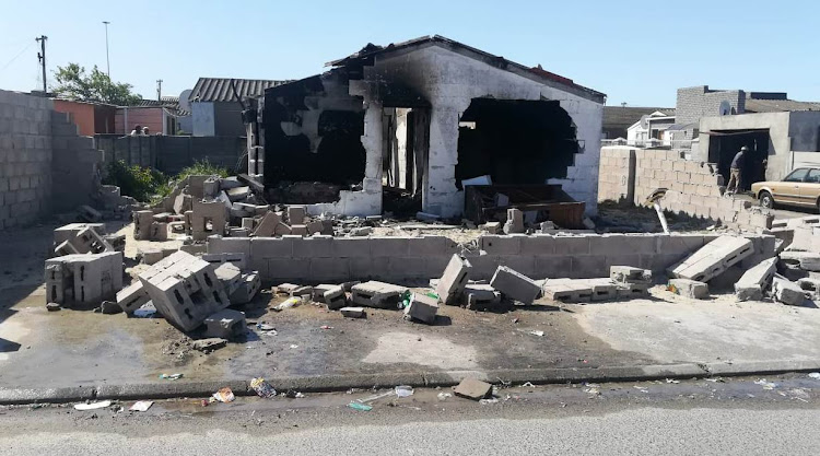 The remains of the Khayelitsha home where Uyinene Mrwetyana's alleged killer lived. Community members set it alight on September 3 2019.