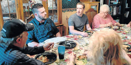 HOUSE CALL: Facebook CEO Mark Zuckerberg at the home of Dan and Lisa Moore of Newton Falls, Ohio. Family members say the dinner was arranged after Zuckerberg saw them on television and wanted to meet them ’to understand why we voted for Trump’.