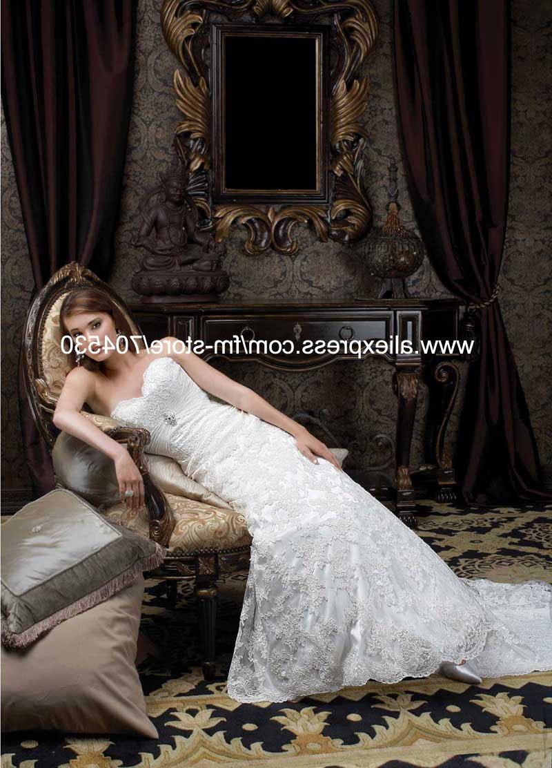 DESCRIPTION: Strapless dress with crystal brooch and chiffon sash on the