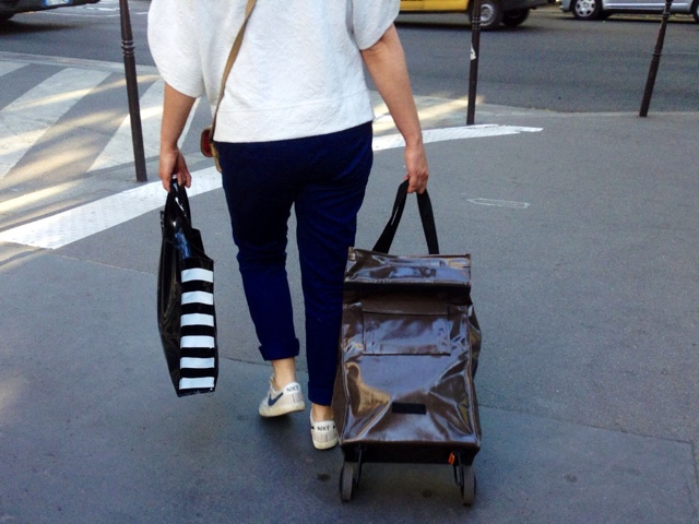 Back of woman with travel bag and small shopping bag