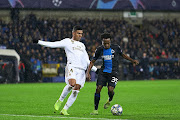 Percy Tau of Club Brugge KV (R) competes for the ball with Casemiro (L) of Real Madrid during a UEFA Champions League group A match at Jan Breydel Stadium. 