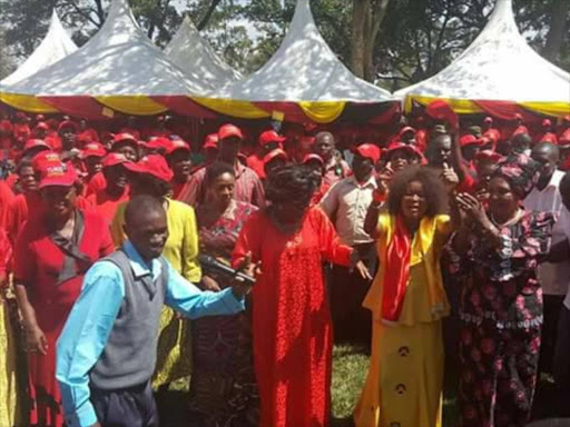 Nairobi woman representative Rachel Shebesh (in red) joins Teso South MP Mary Emaase (right) in a jig at Apokor youth polytechnic in Teso South constituency , BUsia, during a rally on Noevmber 7, 2016. /JANE CHEROTICH