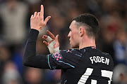 Manchester City attacker Phil Foden celebrates after scoring during their Premier League match against Brighton & Hove Albion at American Express Community Stadium on April 25 2024 in Brighton, England.