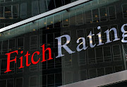 A flag is reflected on the window of the Fitch Ratings headquarters in New York. File photo.