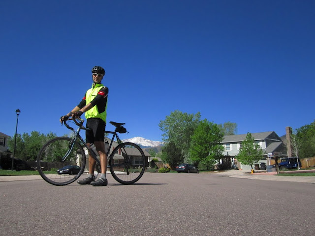 Kitted up for a chilly morning ride on Sue with a snow-capped Pikes Peak in the background
