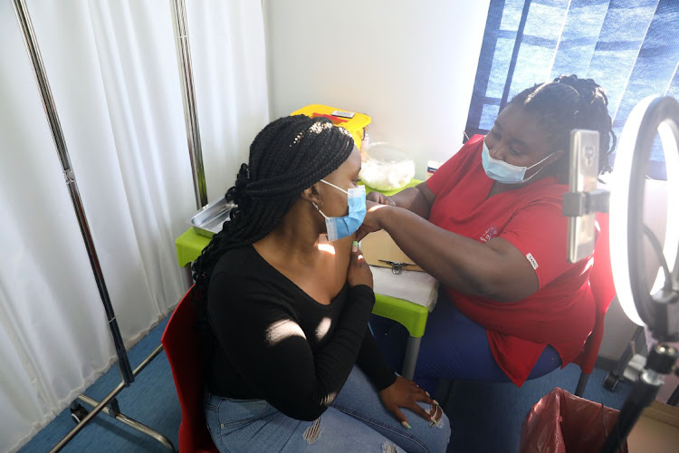 Nurse Celokuhle Msomi administers a vaccine to Neo Nare during the first Vooma Vaccination Weekend campaign in Boksburg in early October. This weekend will see the second instalment of the drive. File photo.