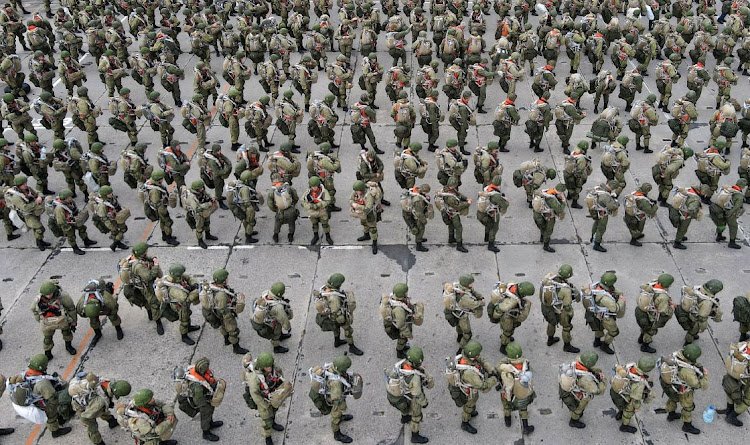 Service members of the Russian airborne forces line up before boarding Ilyushin Il-76 transport planes during drills at a military aerodrome in the Azov Sea port of Taganrog, Russia, on April 22 2021.