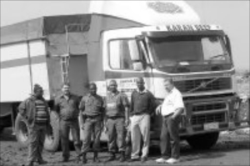 TRUCK STOP: Members of the Benoni police flying squad with the hijacked truck they found. Pic. Mbuzeni Zulu. 18/04/07. © Sowetan.