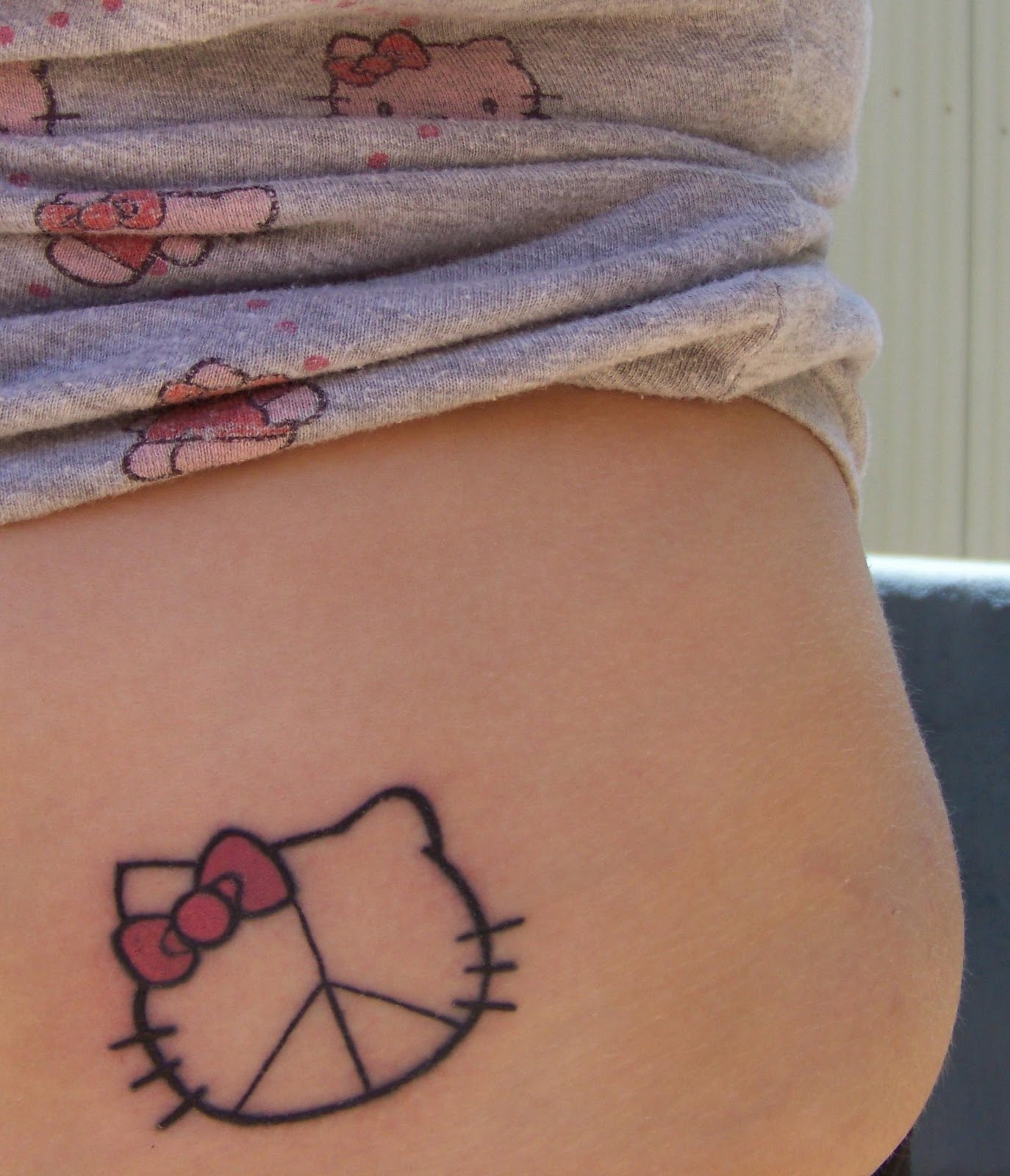 Hello Kitty peace tattoo