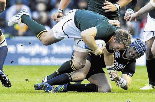 Scotland's Sean Lamont, right, tackles South African captain Jean de Villiers during the Test match at Murrayfield on Saturday. The Boks won 21-10 for their second win of the tour, after beating Ireland last week Picture: DAVID MOIR/GALLO IMAGES