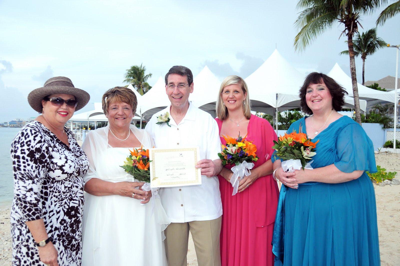 Posing with their Vow Renewal Certificate and the whole group.