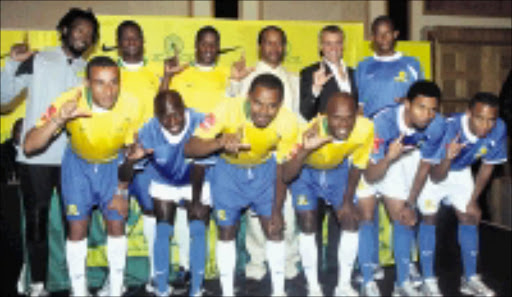 AMBITIOUS: Mamelodi Sundwans boss Patrice Motsepe (light suit) and Nike South Africa's Davide Cardarelli with the new players during the unveliling of the new clun kit at the Holton Hotel in Sandton, Johannesburg yesterday. Pic. Antonio Muchave. 09/07/2008. © Sowetan.