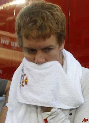 Себастьян Феттель вытирает лицо полотенцем на Гран-при Абу-Даби 2011