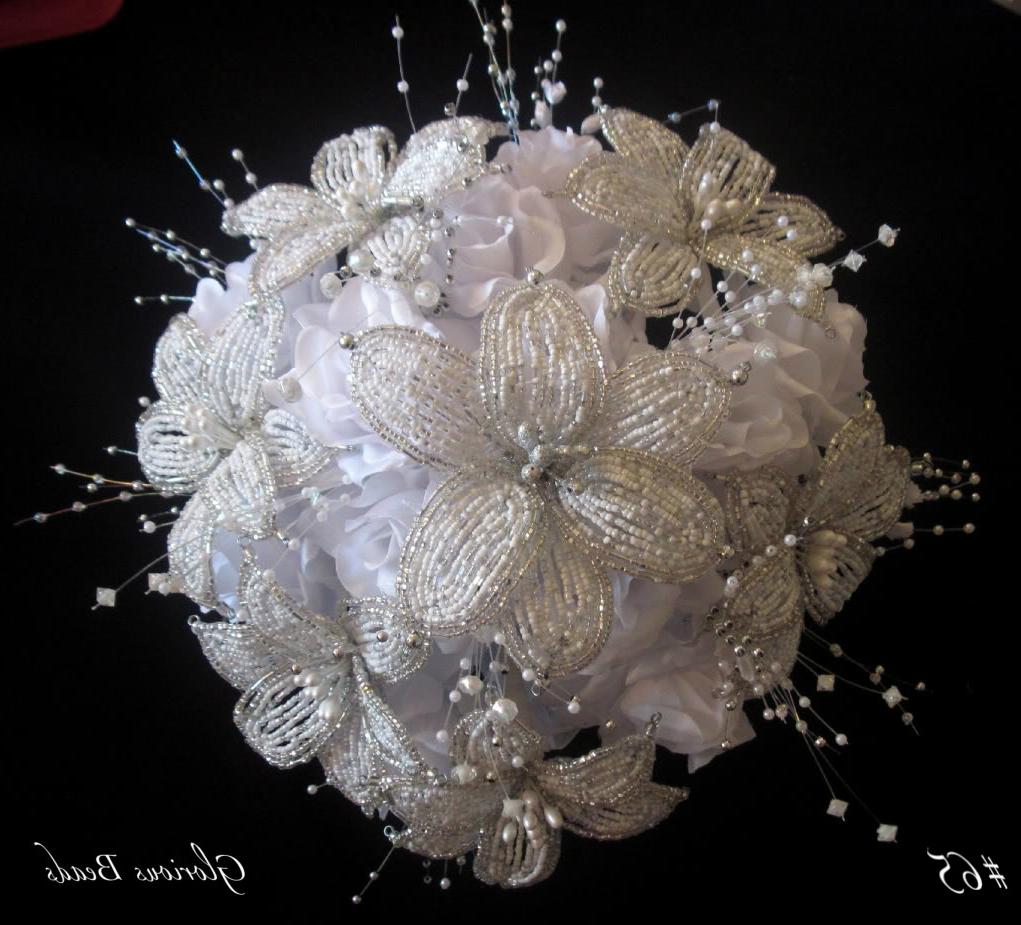 A white organza bow, with tiny silver trim sits underneath the bouquet.