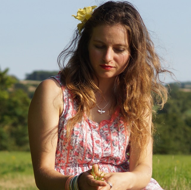 girl sitting in summer meadow