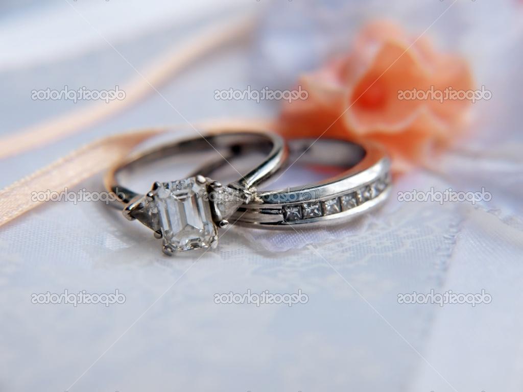 Photo of a diamond & platinum wedding ring on a photo album