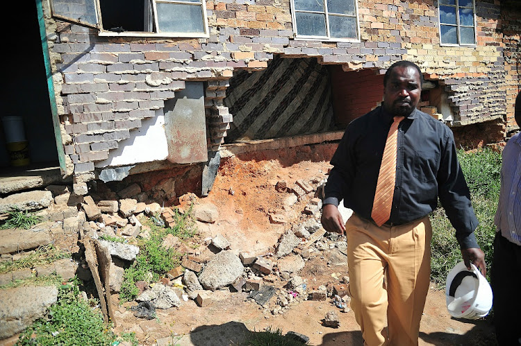 FILE PICTURE: Former MMC for Housing in the City of Johannesburg Dan Bovu looking at a room falling apart at Diepkloof hostel in Soweto.