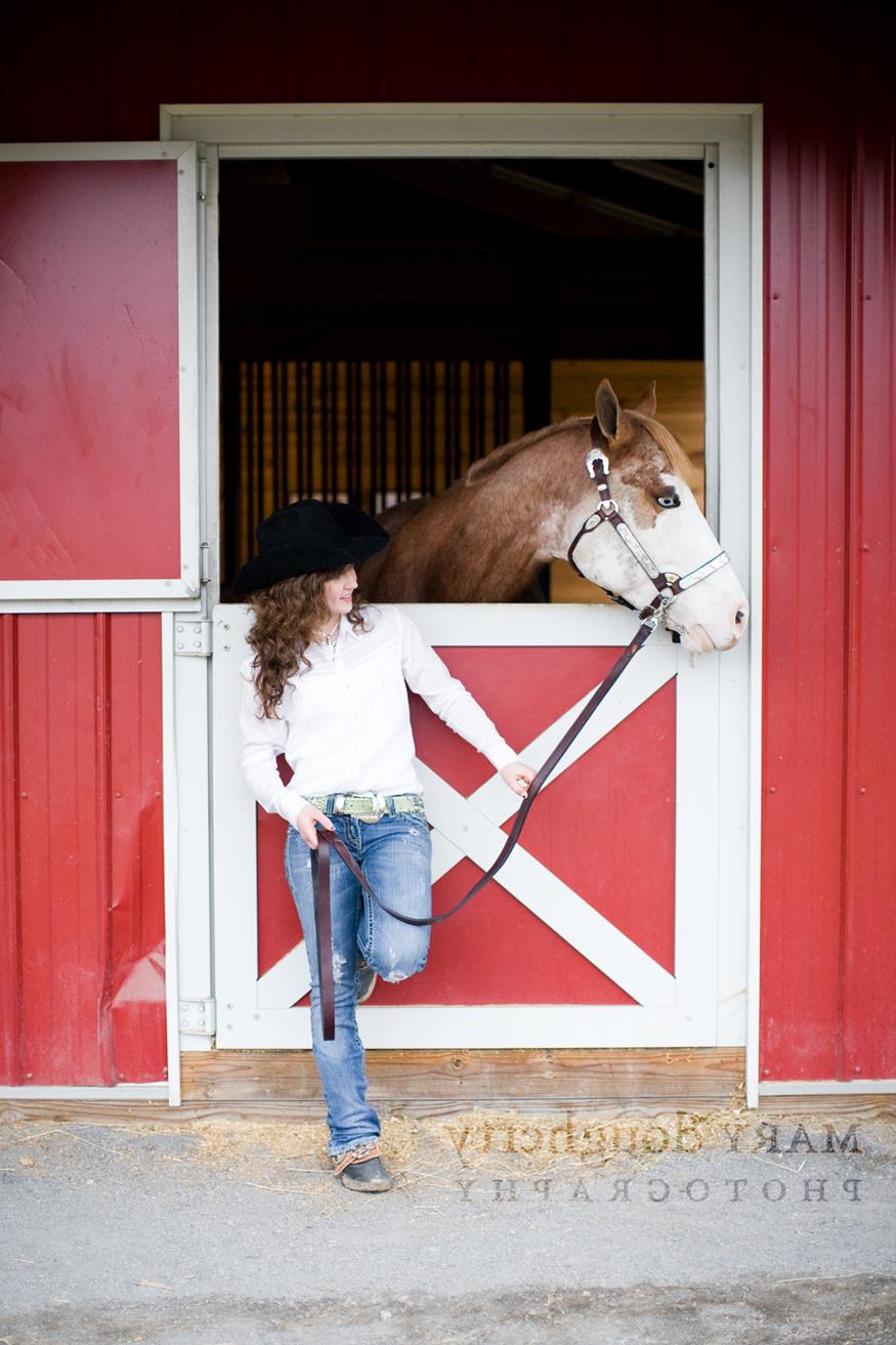 red barn with her horse