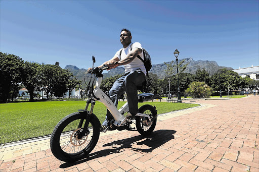 SWITCHED ON: Mohid Reid gets a different view of the city cycling through the Company's Garden on a motorised bicycle