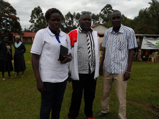 Milka Chepkorir, Charles Langat (in spectacles) and Robinson Kipsang oversee a football tournament that Langat launched to inspire youths. Photo/Courtesy