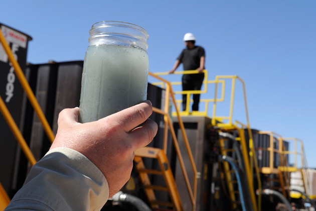 The potential impact of waste from oil and gas drilling — including hydraulic fracturing — on drinking water has been an issue in Texas, Wyoming and, with great urgency, in California this month. Here, a jar of fracking water waste is displayed at a recycling site in Midland, Texas. Photo: Pat Sullivan / AP