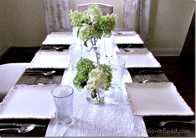 Farmhouse Tablescape Idea using a simple flower arrangement and white dishes
