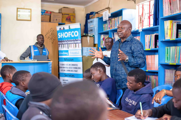 Ugandan MP Hon Charles Bakkabulindi speaking inside one of SHOFCO's school libraries in Kibera on Tuesday, April 23, 2024.